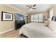 Cozy bedroom featuring a ceiling fan, wood-look floors, and a window with plantation shutters at 22235 Panther Loop, Bradenton, FL 34202