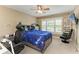 Well-lit bedroom features a ceiling fan, plantation shutters, and plenty of space at 22235 Panther Loop, Bradenton, FL 34202