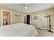 The bedroom features carpet flooring, a ceiling fan, and a decorative mirror above the dresser at 22235 Panther Loop, Bradenton, FL 34202