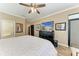 Bright bedroom with wood-look flooring, crown molding, and a large dresser beneath a wall-mounted television at 22235 Panther Loop, Bradenton, FL 34202
