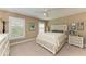 Bedroom with carpet flooring, a ceiling fan, plantation shutters, and a neutral color scheme at 22235 Panther Loop, Bradenton, FL 34202