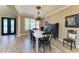 Formal dining room with wood-look floors and elegant chandelier at 22235 Panther Loop, Bradenton, FL 34202