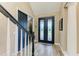 Elegant foyer features a decorative front door and wood-look tile floors at 22235 Panther Loop, Bradenton, FL 34202