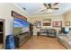 Cozy living room features a ceiling fan, hardwood floors, and ample wall decor at 22235 Panther Loop, Bradenton, FL 34202