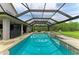 This backyard has a private screened pool and spa with stone trim plus an outdoor grill area at 22235 Panther Loop, Bradenton, FL 34202