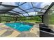 The screened pool and spa are surrounded by stone pavers and offer a relaxing backyard view at 22235 Panther Loop, Bradenton, FL 34202