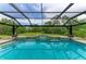 Screened pool with attached spa offers a serene outdoor living space and a beautiful backyard view at 22235 Panther Loop, Bradenton, FL 34202