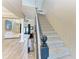 A bright foyer features a carpeted staircase, wood floors, and an open view of the living room with plenty of natural light at 22235 Panther Loop, Bradenton, FL 34202
