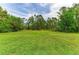 Expansive and beautifully maintained lawn offers a peaceful and private outdoor space at 22235 Panther Loop, Bradenton, FL 34202