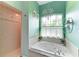 Bright bathroom featuring a soaking tub under a window and a separate shower with tiled walls at 22333 Panther Loop, Bradenton, FL 34202