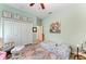 Serene bedroom with light green walls, floral art, and a cozy sitting area at 22333 Panther Loop, Bradenton, FL 34202