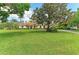 Beautiful single-story home surrounded by mature trees and green lawn at 22333 Panther Loop, Bradenton, FL 34202