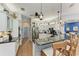 Stylish kitchen with granite countertops, pendant lights, white cabinetry, stainless appliances, and hardwood flooring at 22333 Panther Loop, Bradenton, FL 34202