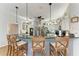 Contemporary kitchen with a large island, granite countertops, modern lighting, and stainless steel appliances at 22333 Panther Loop, Bradenton, FL 34202