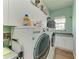 Well-organized laundry room features a modern LG washer and dryer and ample cabinet space at 22333 Panther Loop, Bradenton, FL 34202