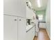 Spacious laundry room with modern appliances, a utility sink, and ample storage cabinets at 22333 Panther Loop, Bradenton, FL 34202