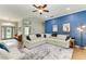 Bright living room featuring a large sectional sofa, complemented by hardwood flooring and blue accent wall with stylish decor at 22333 Panther Loop, Bradenton, FL 34202