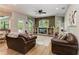 Spacious living room with stacked stone accent wall, built-in shelving and pool views at 22333 Panther Loop, Bradenton, FL 34202