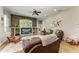 Living room with stacked stone accent wall, built-in shelving and wood flooring at 22333 Panther Loop, Bradenton, FL 34202