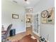 Bright office space with wood flooring and glass door leading to the living area at 22333 Panther Loop, Bradenton, FL 34202