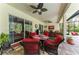 Covered patio offers outdoor seating with ceiling fans and views of the screened-in pool and lanai at 22333 Panther Loop, Bradenton, FL 34202