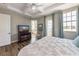 Bright and airy bedroom features coffered ceilings, wood floors, and natural light at 2309 Avenue C # 100, Bradenton Beach, FL 34217