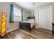 Bedroom featuring a window with curtain accents, wood-look flooring and a closet at 2309 Avenue C # 100, Bradenton Beach, FL 34217