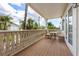 Balcony/deck area with wood flooring and a table and chairs at 2309 Avenue C # 100, Bradenton Beach, FL 34217