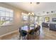 Bright dining room featuring a large wooden table, modern chairs, and windows with scenic views and natural lighting at 2309 Avenue C # 100, Bradenton Beach, FL 34217