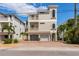 Stunning three-story home with balconies, a two-car garage, and lush landscaping at 2309 Avenue C # 100, Bradenton Beach, FL 34217