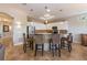 A modern kitchen with white cabinetry, pendant lighting, stainless steel appliances, and a breakfast bar with seating at 2309 Avenue C # 100, Bradenton Beach, FL 34217