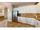 A bright kitchen featuring stainless steel appliances, granite countertops, and white cabinets for storage at 2309 Avenue C # 100, Bradenton Beach, FL 34217