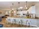 Open kitchen with a spacious island, pendant lighting, and modern amenities at 2309 Avenue C # 100, Bradenton Beach, FL 34217