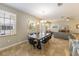 Open-concept living space with a dining table, comfortable seating, and large windows at 2309 Avenue C # 100, Bradenton Beach, FL 34217