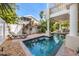 A relaxing outdoor living space featuring a pool, lounge chairs and lush landscaping at 2309 Avenue C # 100, Bradenton Beach, FL 34217