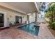 Refreshing private pool with brick patio, columns, and seating area, perfect for relaxation and entertaining at 2309 Avenue C # 100, Bradenton Beach, FL 34217