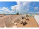 Spacious roof deck with lounge chairs, white railings and panoramic views at 2309 Avenue C # 100, Bradenton Beach, FL 34217