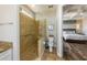 Bathroom showcasing a glass-enclosed shower, neutral tiling, a toilet, and vanity at 2309 Avenue C # 200, Bradenton Beach, FL 34217