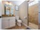 Bathroom features granite counters, white cabinets, a walk-in shower, and tile flooring at 2309 Avenue C # 200, Bradenton Beach, FL 34217