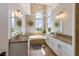Bathroom boasts granite counters, double sinks, a soaking tub, and decorative mirrors at 2309 Avenue C # 200, Bradenton Beach, FL 34217