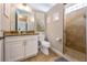 Bright bathroom featuring granite countertop, white cabinetry, and a glass-enclosed shower at 2309 Avenue C # 200, Bradenton Beach, FL 34217