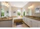 Well-appointed bathroom with dual vanities, granite countertops, and a soaking tub at 2309 Avenue C # 200, Bradenton Beach, FL 34217