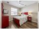 Comfortable bedroom featuring a red bed frame, TV, ceiling fan and lots of natural light at 2309 Avenue C # 200, Bradenton Beach, FL 34217