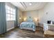 Bedroom with a king-size bed, wood floors, and a large window with natural light at 2309 Avenue C # 200, Bradenton Beach, FL 34217