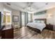 Bedroom featuring a wood bed with a white comforter, recessed ceiling, and wood-look flooring at 2309 Avenue C # 200, Bradenton Beach, FL 34217