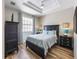 Bedroom showcasing a dark wood bedroom set with light blue accents and wood floors at 2309 Avenue C # 200, Bradenton Beach, FL 34217