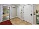 A bright hallway with neutral-toned walls and tiled floors leads to a sunny outdoor sitting area in the home at 2309 Avenue C # 200, Bradenton Beach, FL 34217