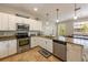 Well-equipped kitchen featuring stainless steel appliances, granite counters, and bright natural light at 2309 Avenue C # 200, Bradenton Beach, FL 34217