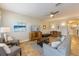 Neutral living room with tile floors, a ceiling fan, and wood entertainment center at 2309 Avenue C # 200, Bradenton Beach, FL 34217