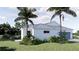 Stunning white home featuring a metal roof, landscaping, and a convenient two car garage at 2508 Belvoir Blvd, Sarasota, FL 34237